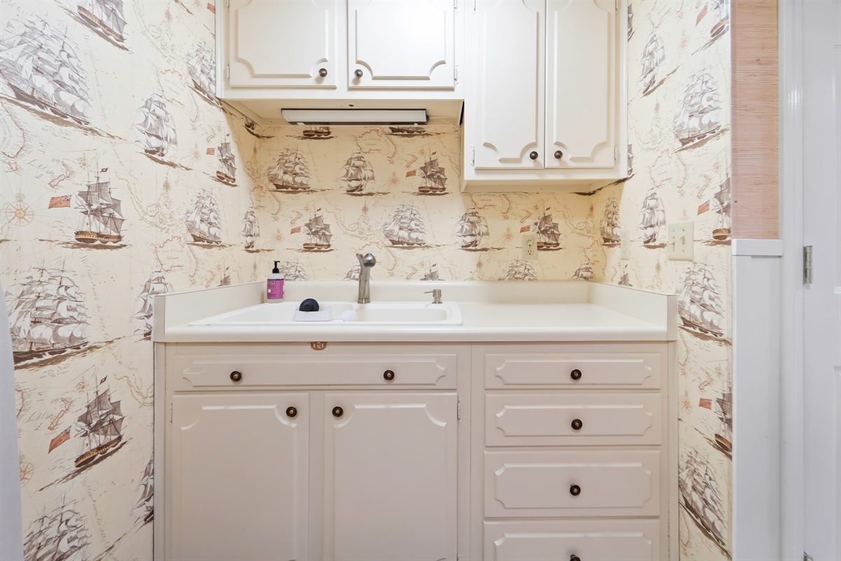 There's a full sink set-up with dish drying rack for easy clean-up in the basement kitchenette.