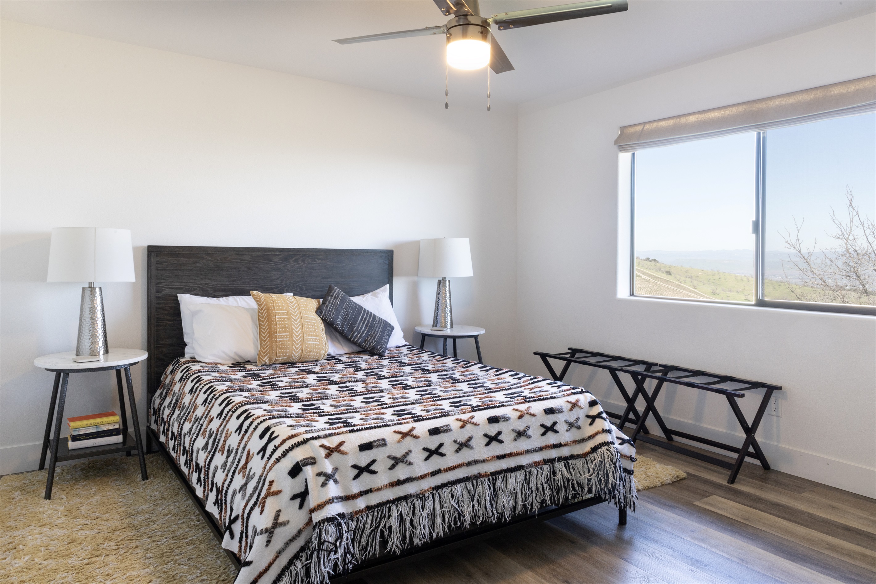Wake up to sweeping vineyard and mountain views from this beautifully styled queen bedroom. The hilltop is yours.