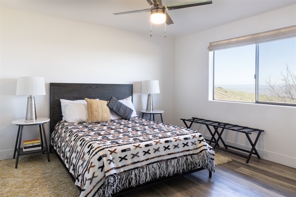 Wake up to sweeping vineyard and mountain views from this beautifully styled queen bedroom. The hilltop is yours.