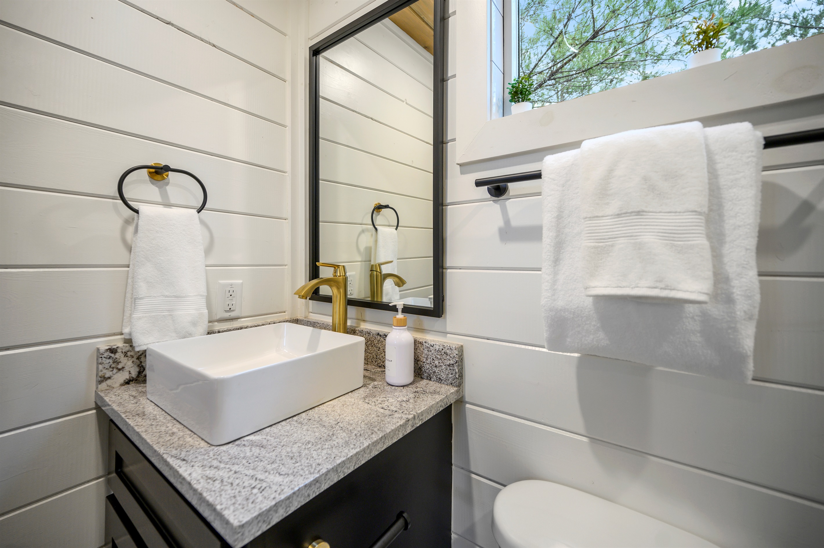 A complete bathroom setup featuring both tub and shower, providing flexibility and convenience throughout your stay