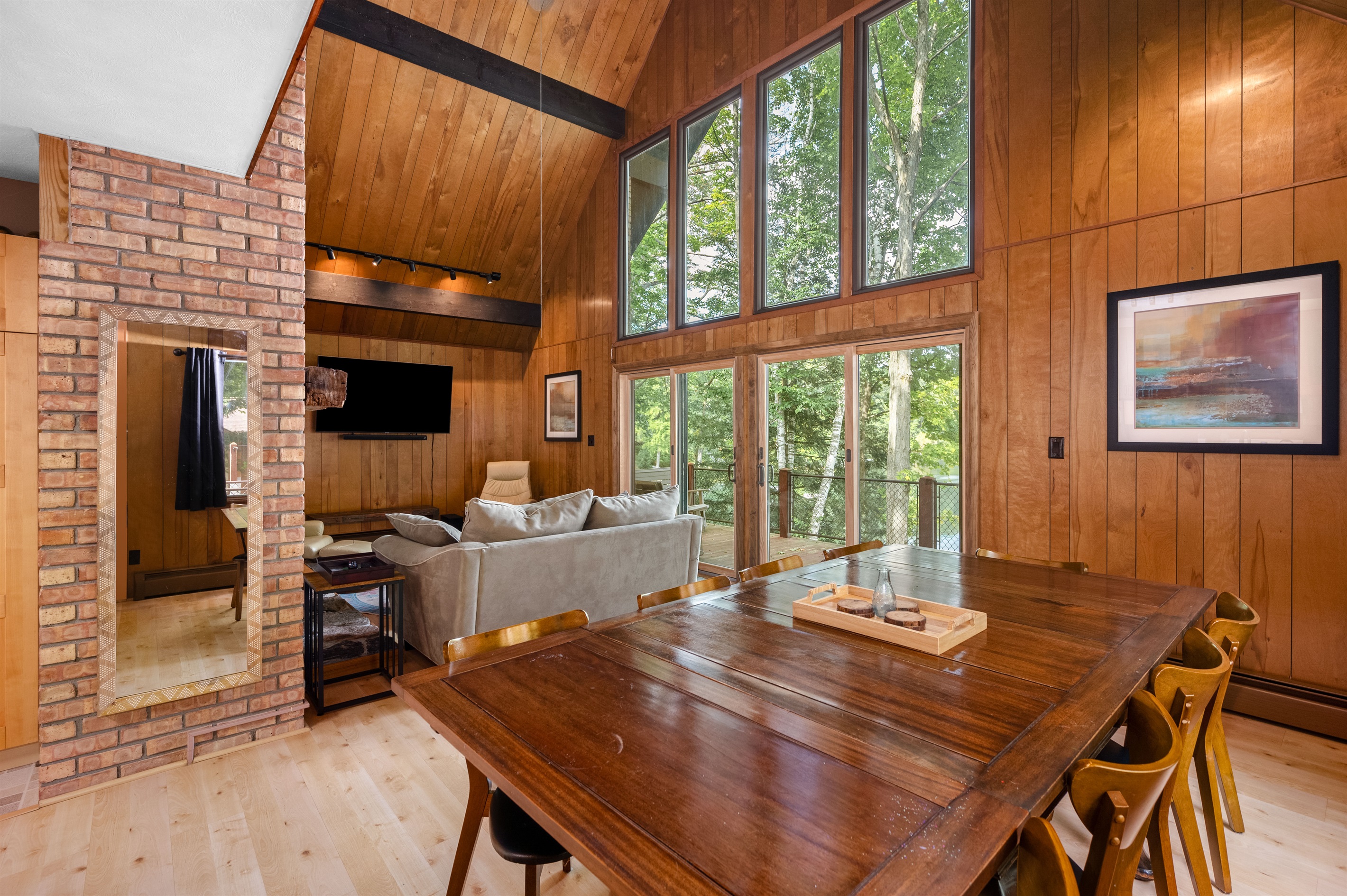 Living room with vaulted ceilings, fireplace, and lake views
