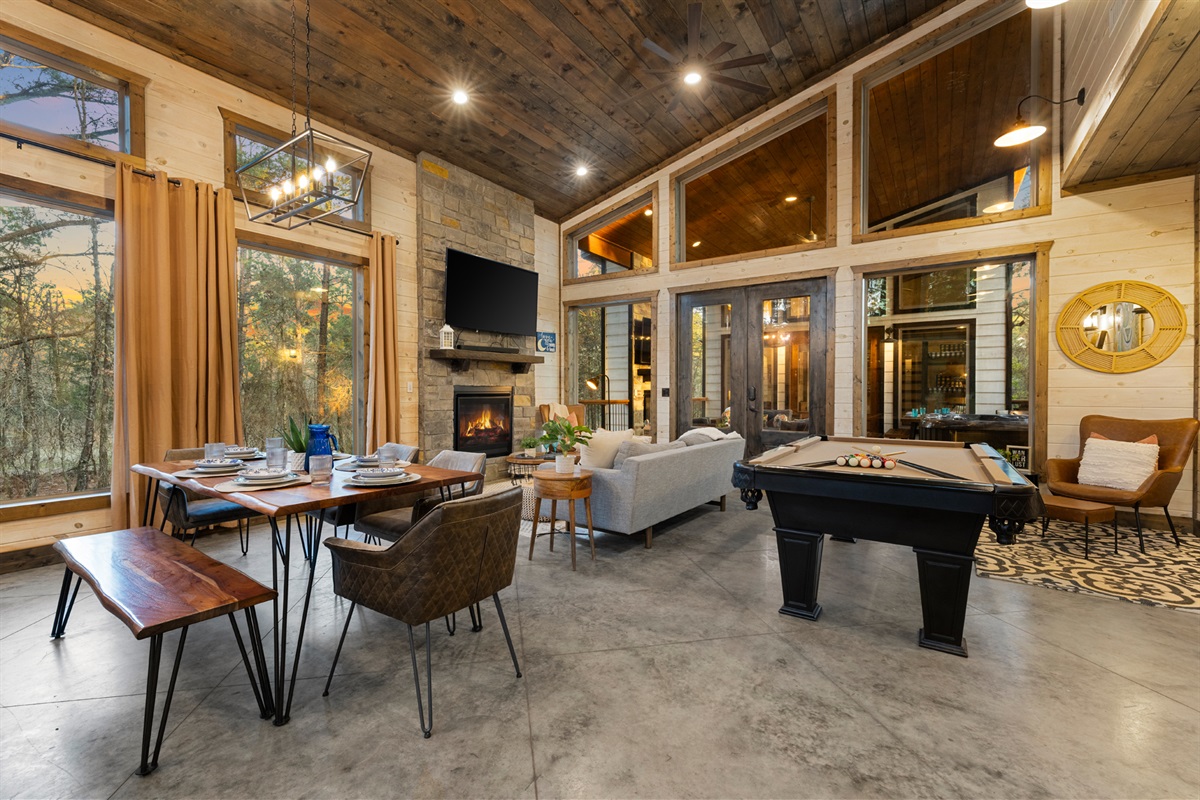 Bright windows frame the trees while you cook and connect. It is the kind of kitchen that makes pancake mornings and charcuterie nights feel simple and special.