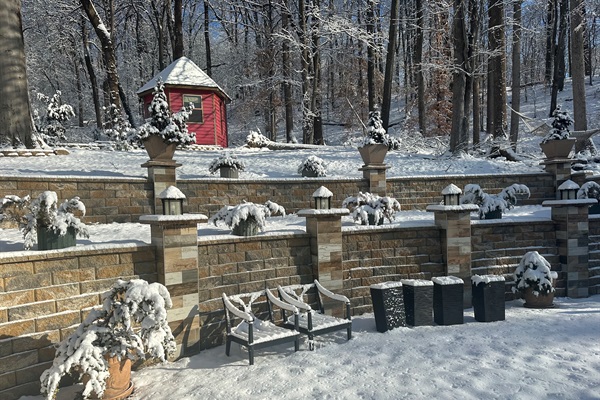 Winter view of Japanese Tea House and decorative stone retaining. wall.