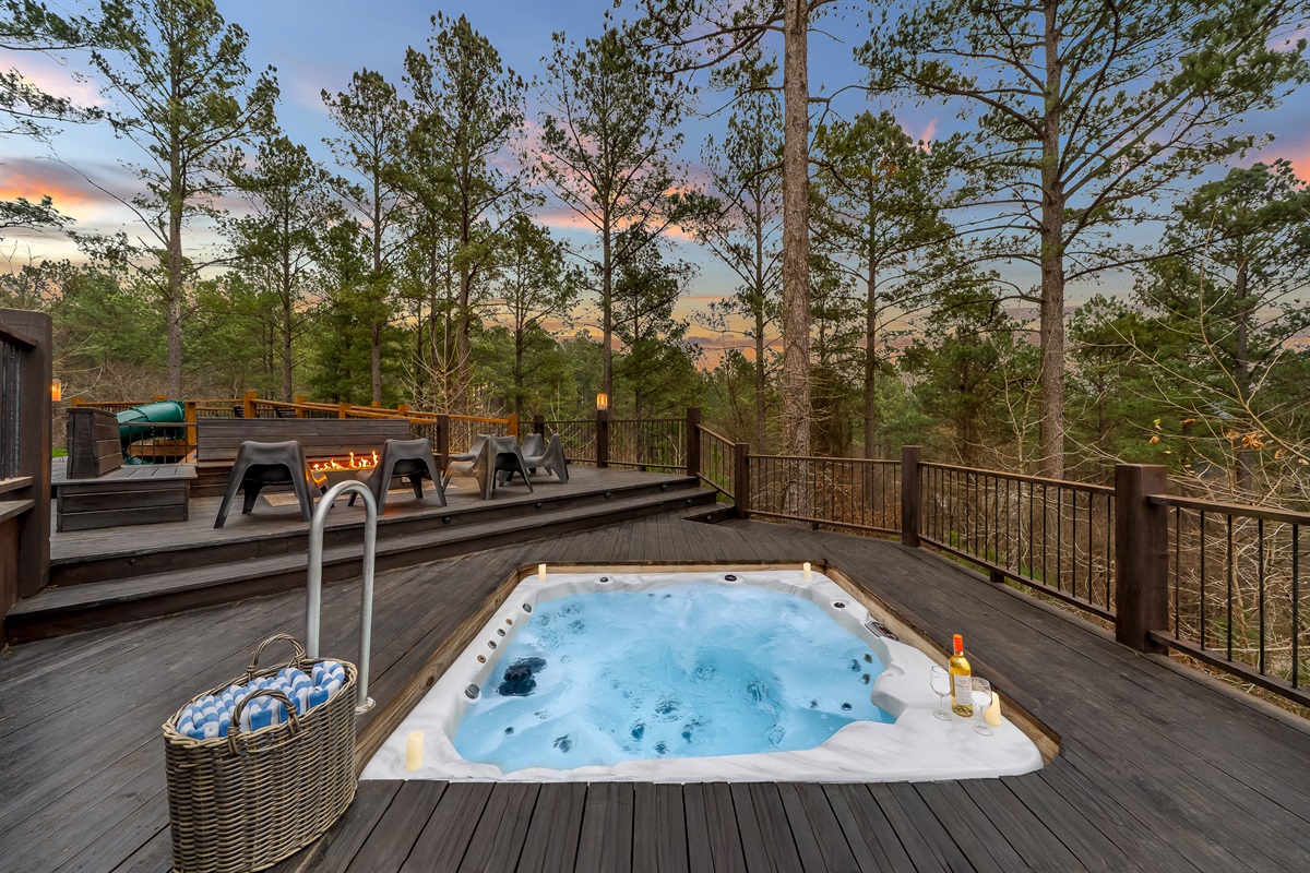 Unwind in the sunken hot tub with forest views and warm evening glow. 