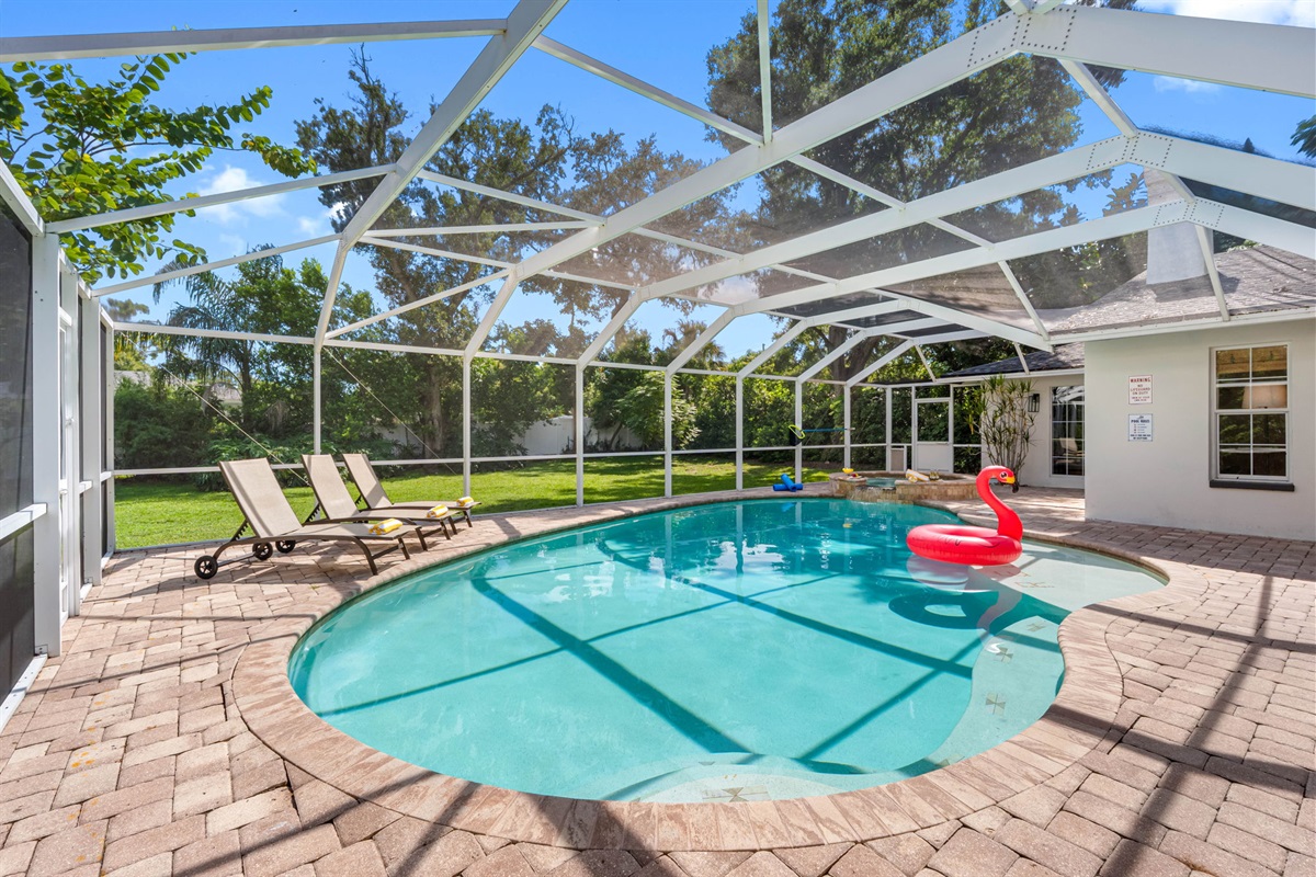 Outdoor entertaining paradise with poolside dining and spa seating.