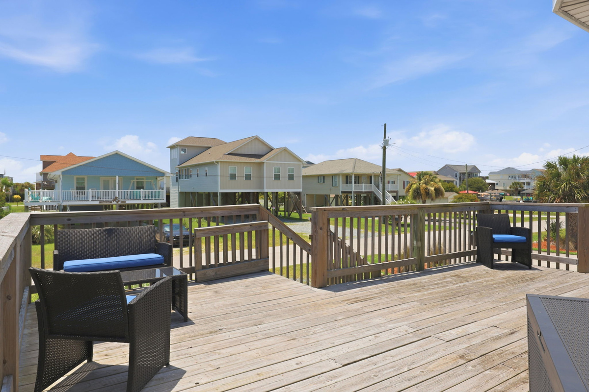 Large front deck with outdoor seating and views of the charming beach neighborhood