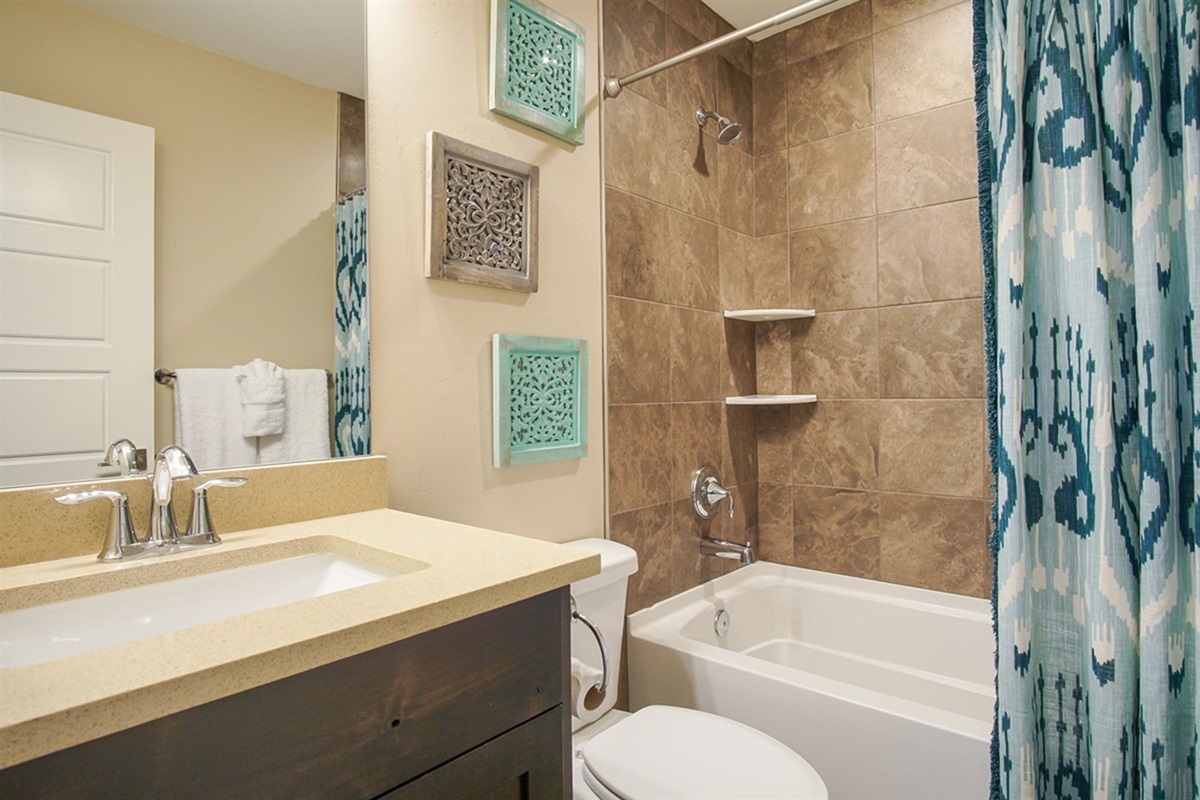 Full bathroom with tub/shower combo—clean, bright, and functional.