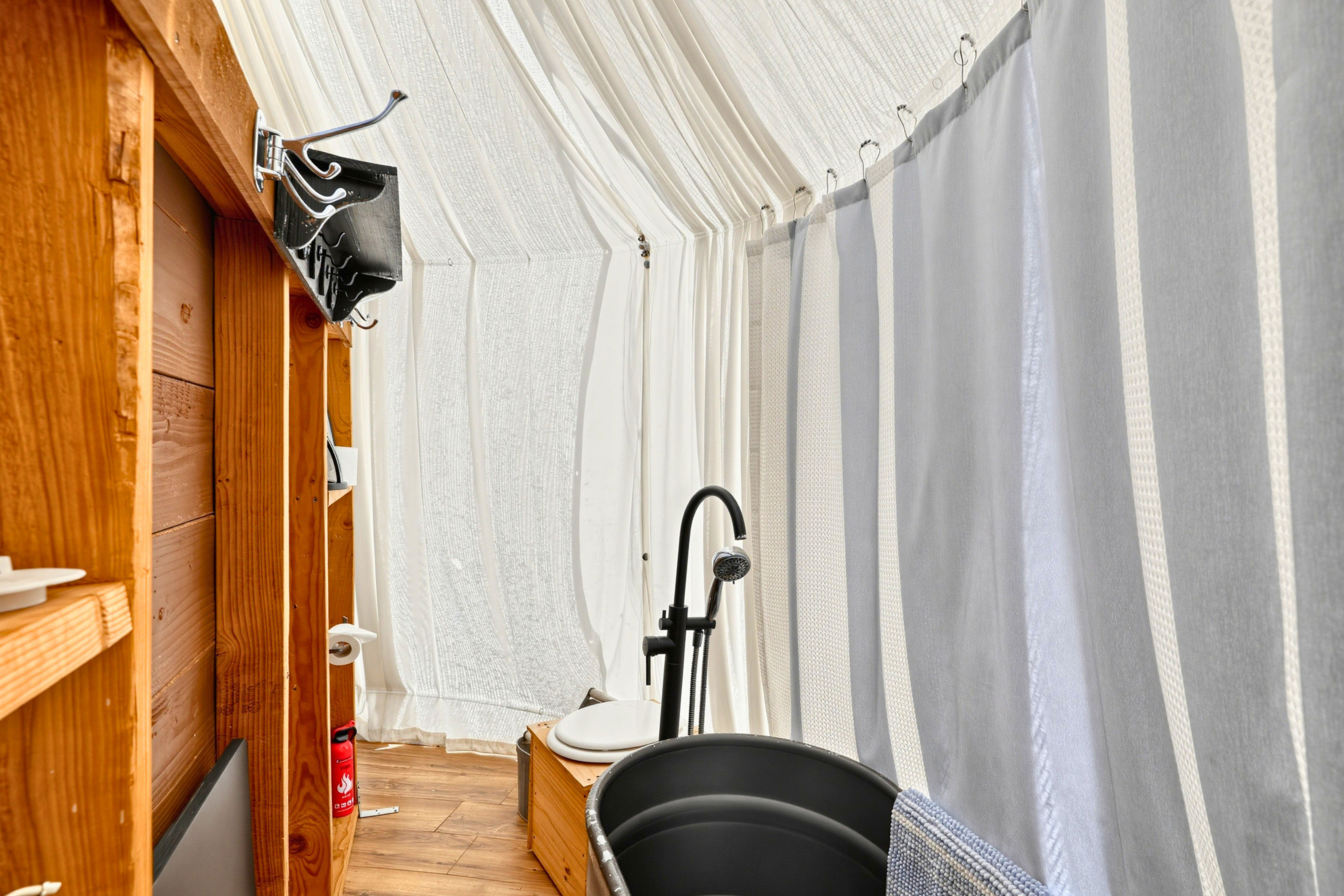 Enjoy the convenience of a private bathroom with a bathtub and composting toilet