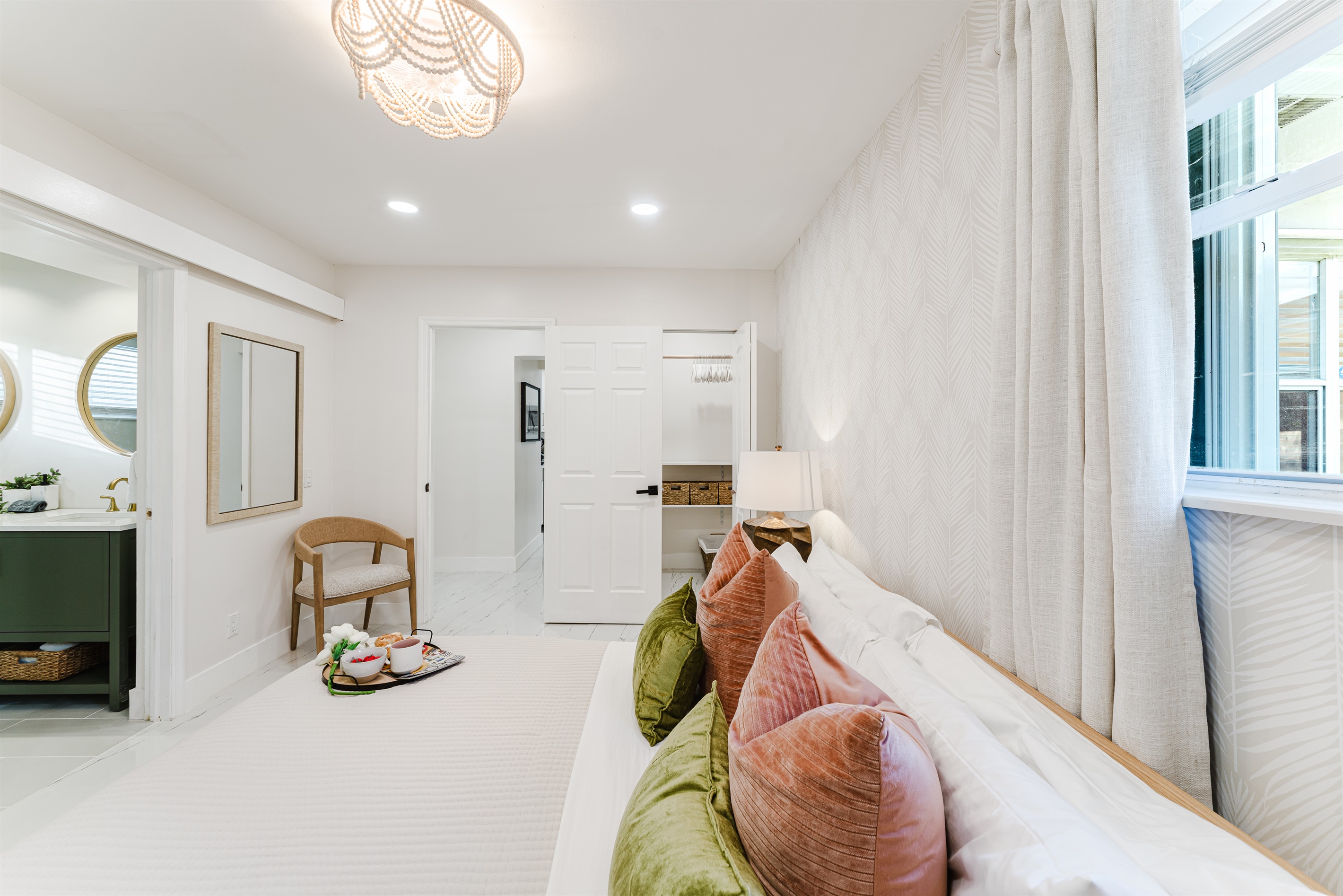 Primary king suite designed for rest and privacy, featuring fresh cotton linens, a Smart TV, and serene Palm Beach–inspired finishes. Includes a walk-in closet and private en-suite bathroom for a comfortable, hotel-style stay.