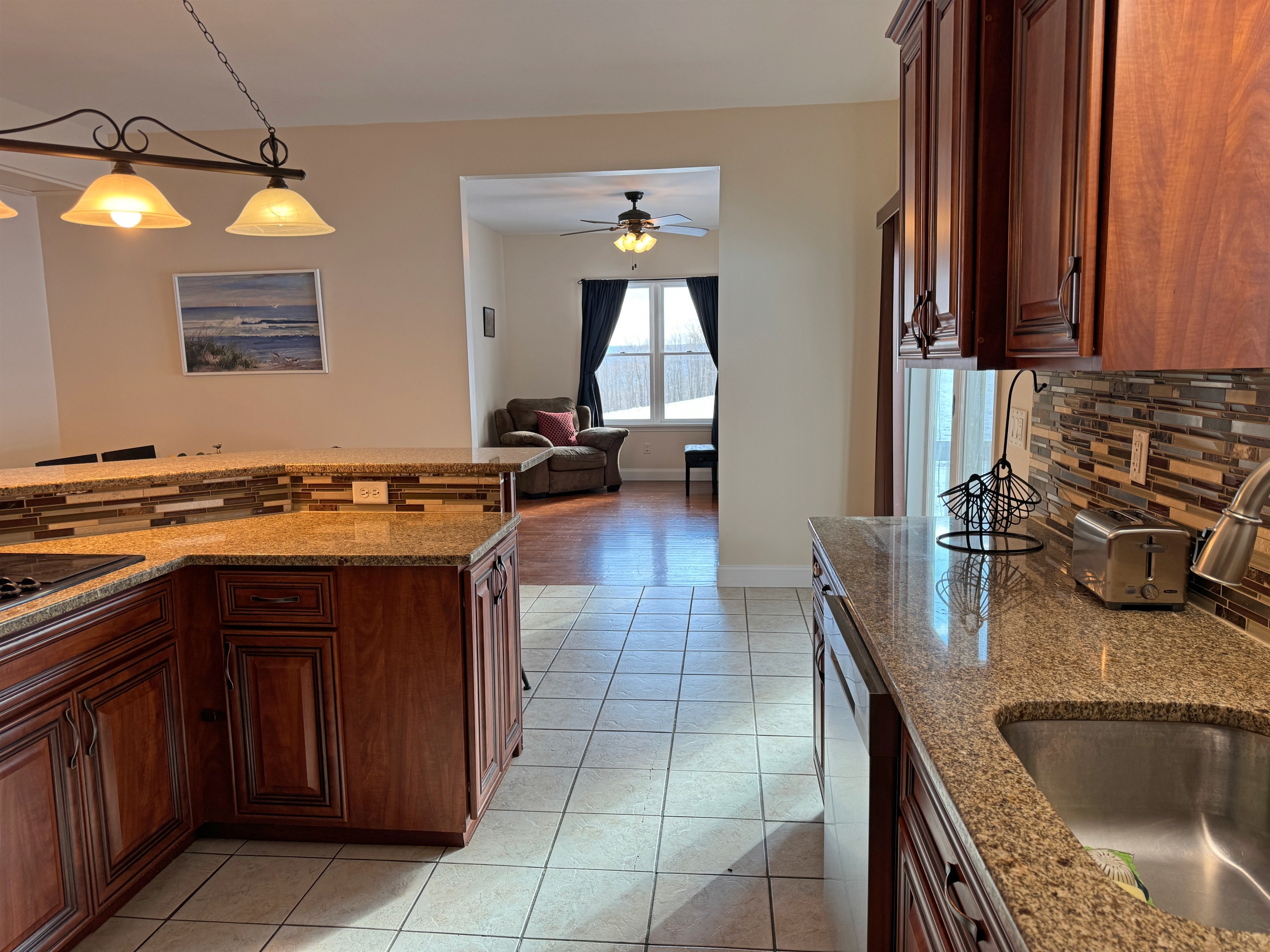 Kitchen and sitting room with piano beyond