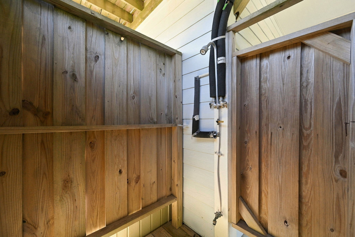 Enjoy the convenience of an outdoor shower after sun-soaked beach adventures, keeping the sand outside and relaxation inside!