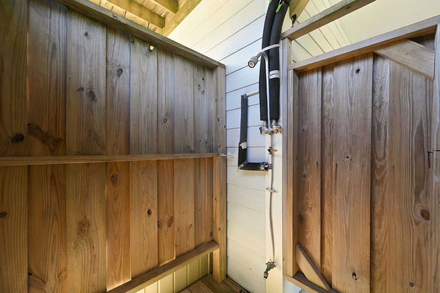 Enjoy the convenience of an outdoor shower after sun-soaked beach adventures, keeping the sand outside and relaxation inside!