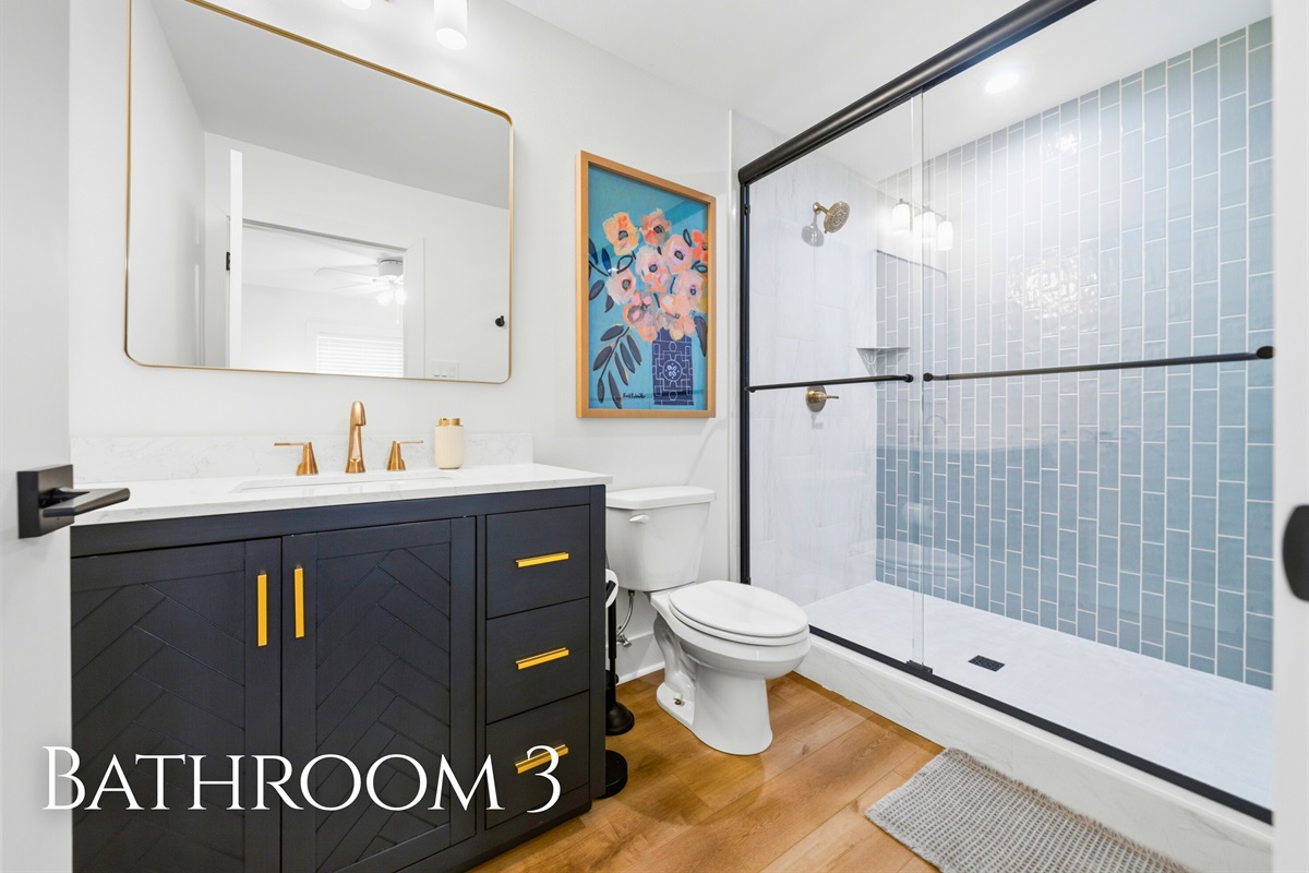 A modern vanity paired with a spacious walk-in shower provides both style and everyday convenience.