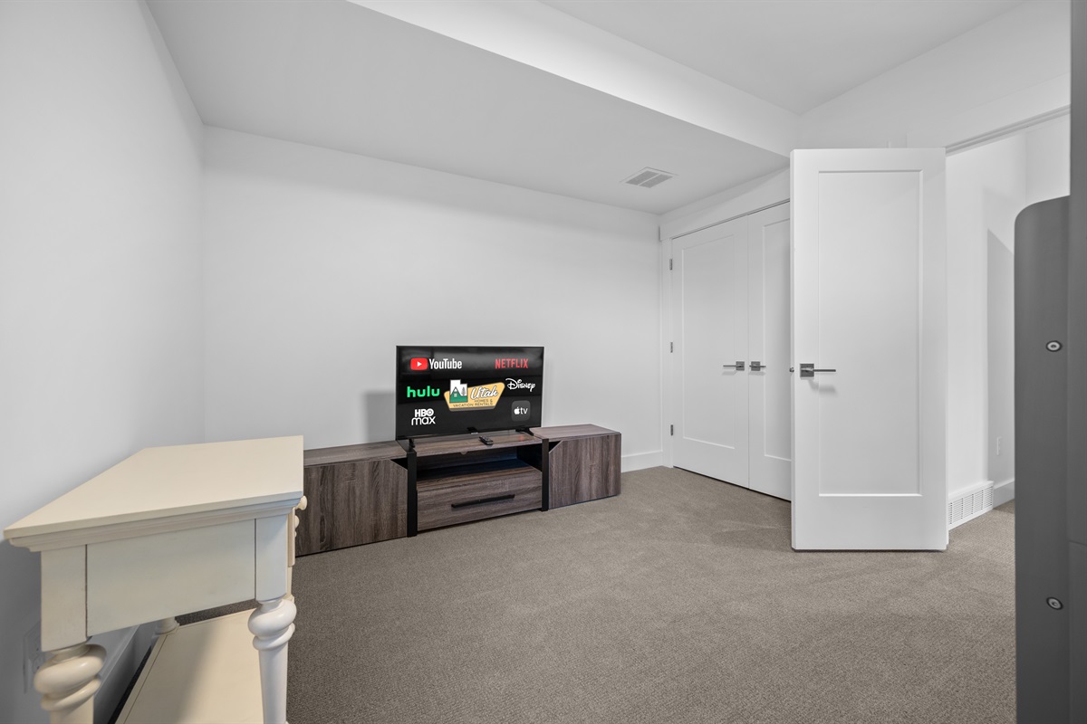 Spacious lower-level bunk room with Smart TV and seating area — perfect for kids or groups.