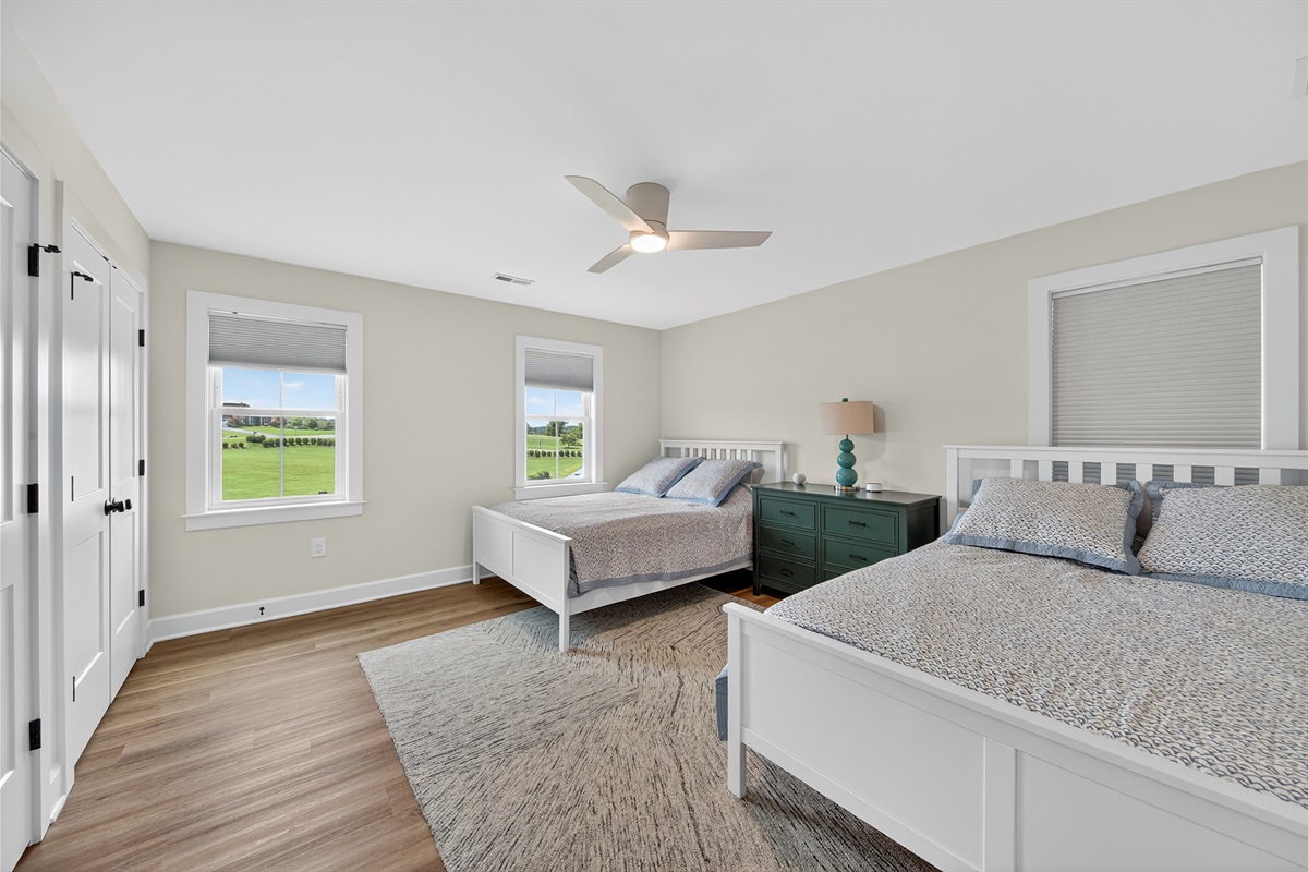 Roomy and restful, this guest room includes two queen beds and plenty of space.