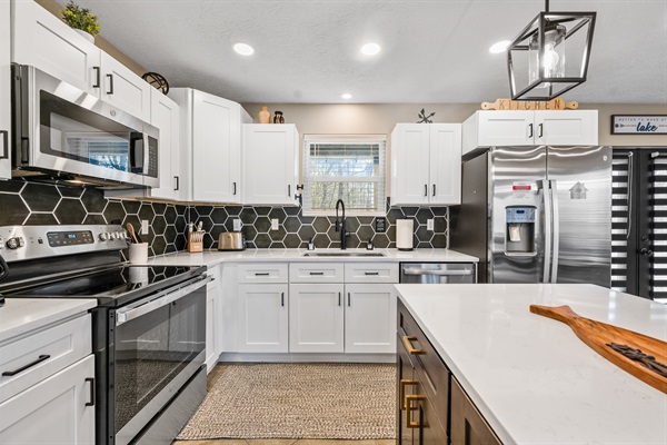 The kitchen and dining area feature new appliances and all the essentials you need to cook, serve, and enjoy meals with family and friends.  A small selection of spices is provided in the cabinet next to the microwave.