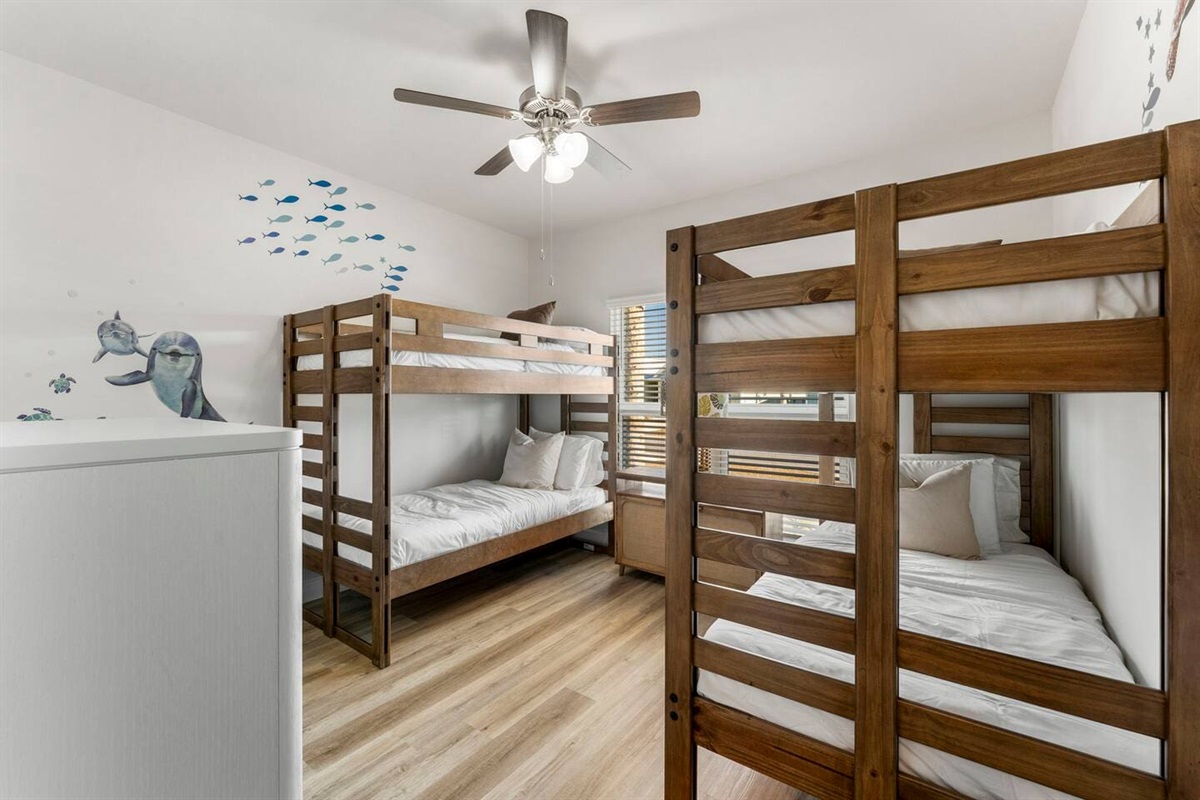 Comfortable bedroom with two bunk beds and windows for a fresh, open feel