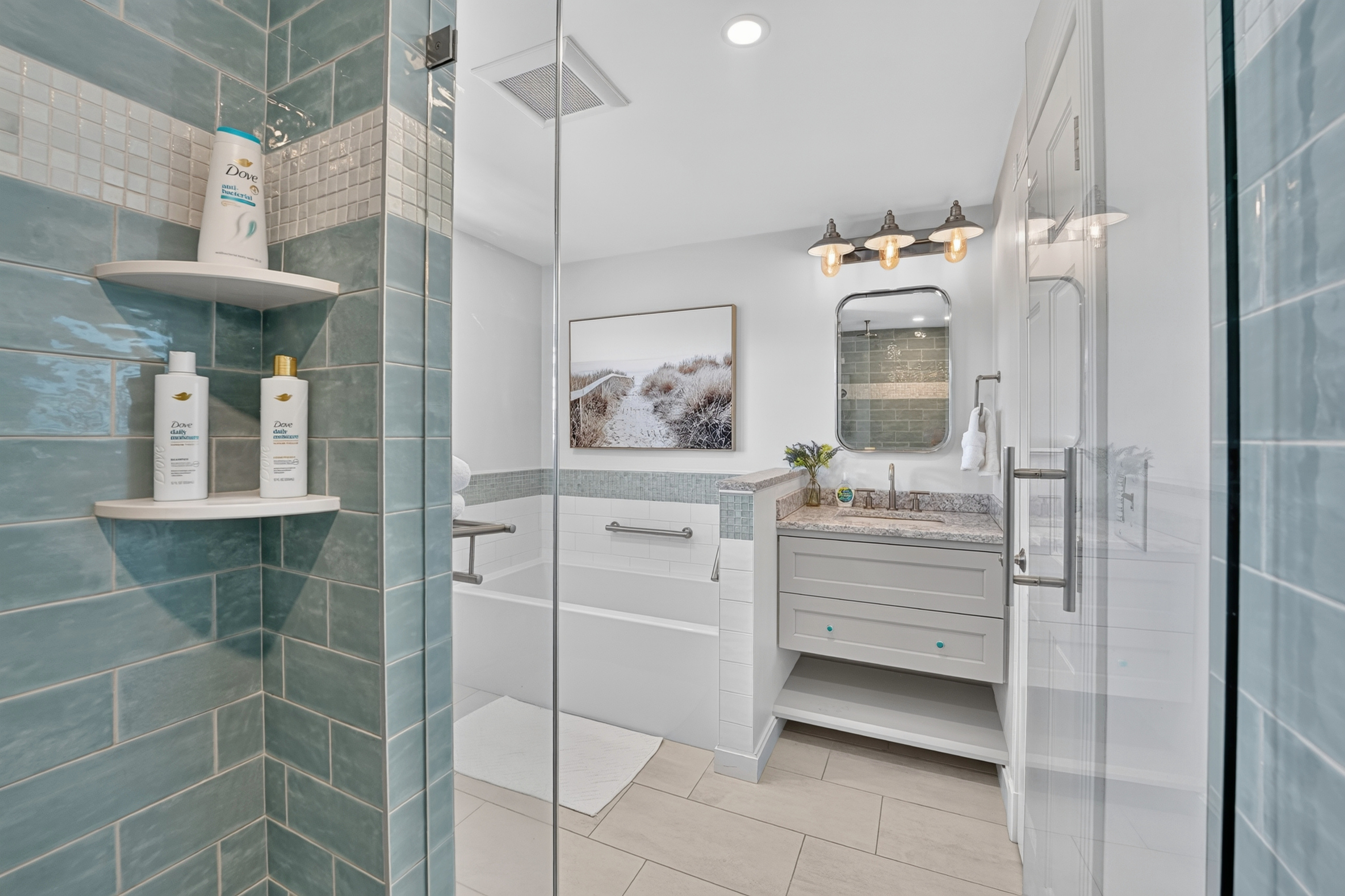 Spacious glass-enclosed shower complements this bright, modern full bathroom.