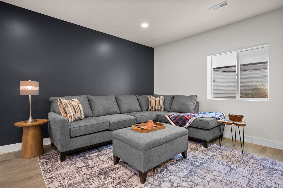 Modern living room with cozy sectional and chic accent wall.