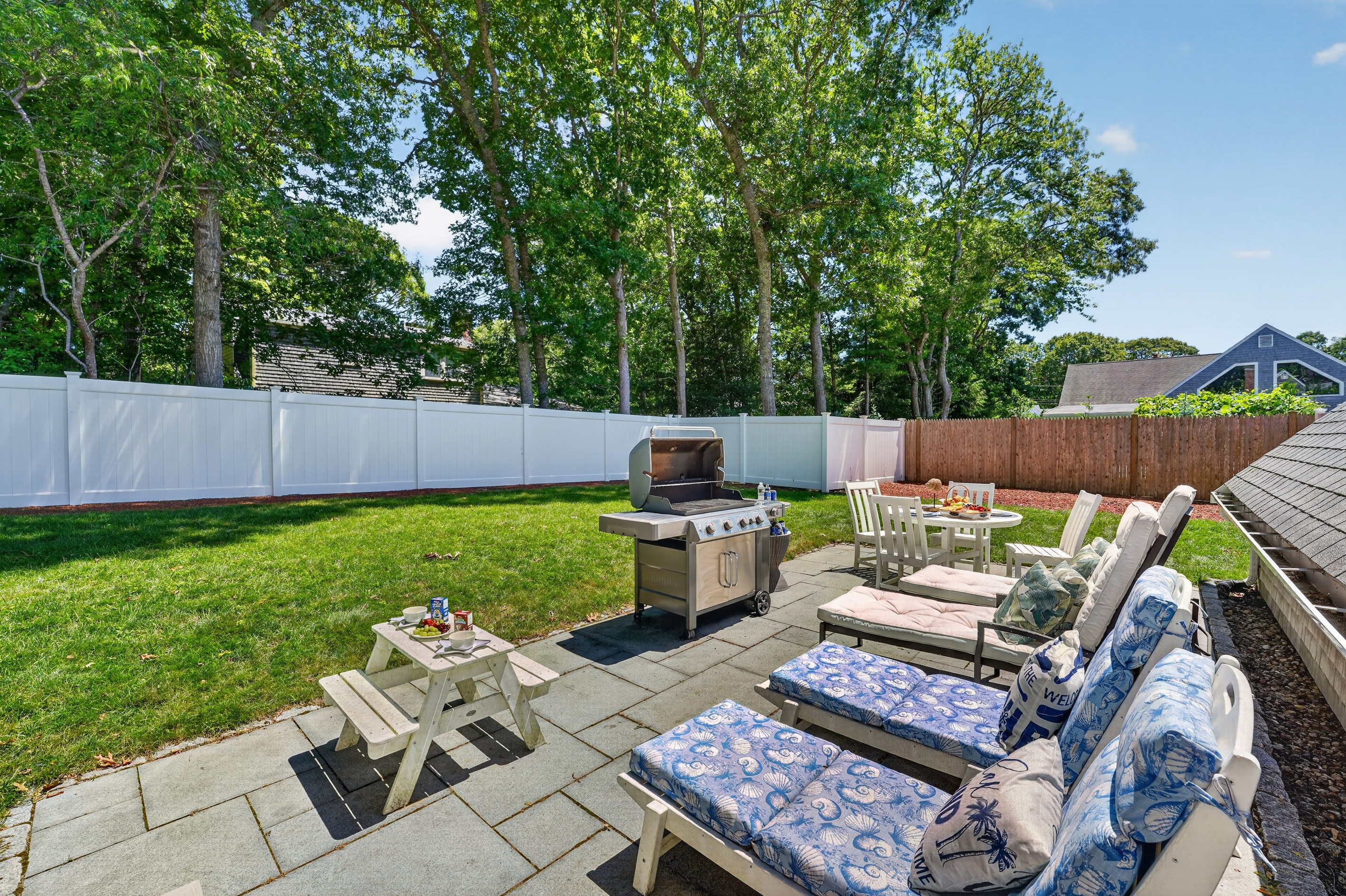Private backyard patio with lounge seating, a BBQ grill, and plenty of space to unwind.