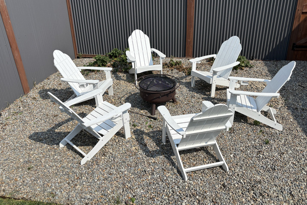 Gather 'round the fire pit — six Adirondack chairs in the fenced backyard, one for every guest. S'mores strongly encouraged.