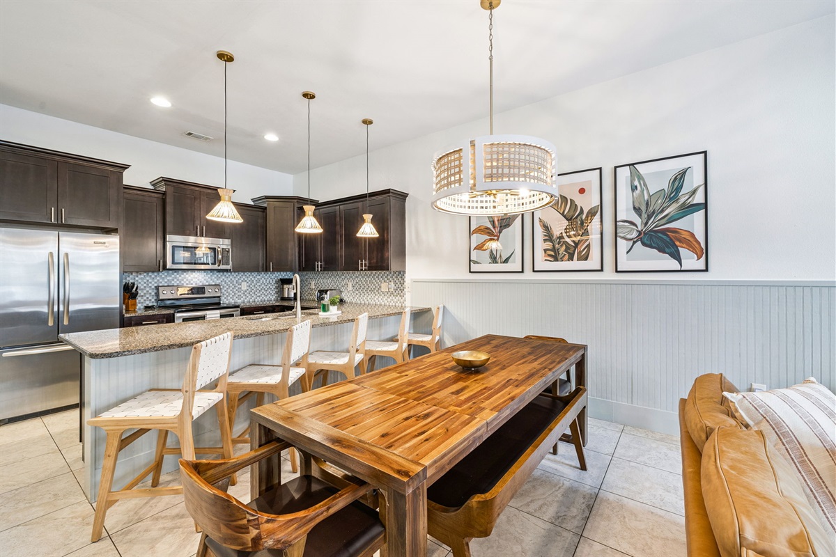 Enjoy effortless vacation living in this bright, open-plan space where the dining area, and fully equipped kitchen flow together beautifully. Whether you're cooking, relaxing, or sharing meals, everyone stays connected.
