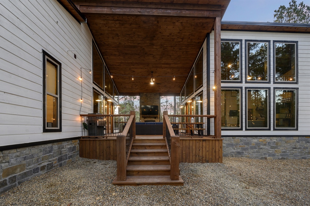 Step onto the covered deck for cozy nights, outdoor dining, and peaceful forest views at Piece of the Moon.