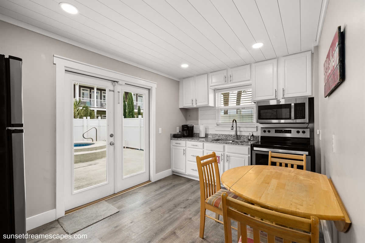 Just off the second living room is the second kitchen. This room provides access to the backyard and private pool.