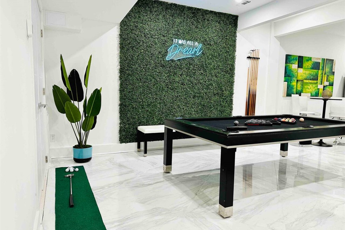 Enjoy our pool table, mini golf & neon backdrop.