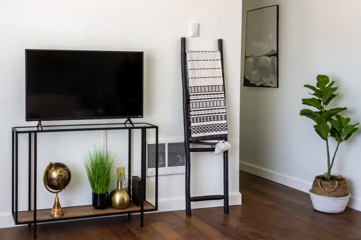A cozy console with a globe and a soft throw ladder invite you to slow down and get comfortable.