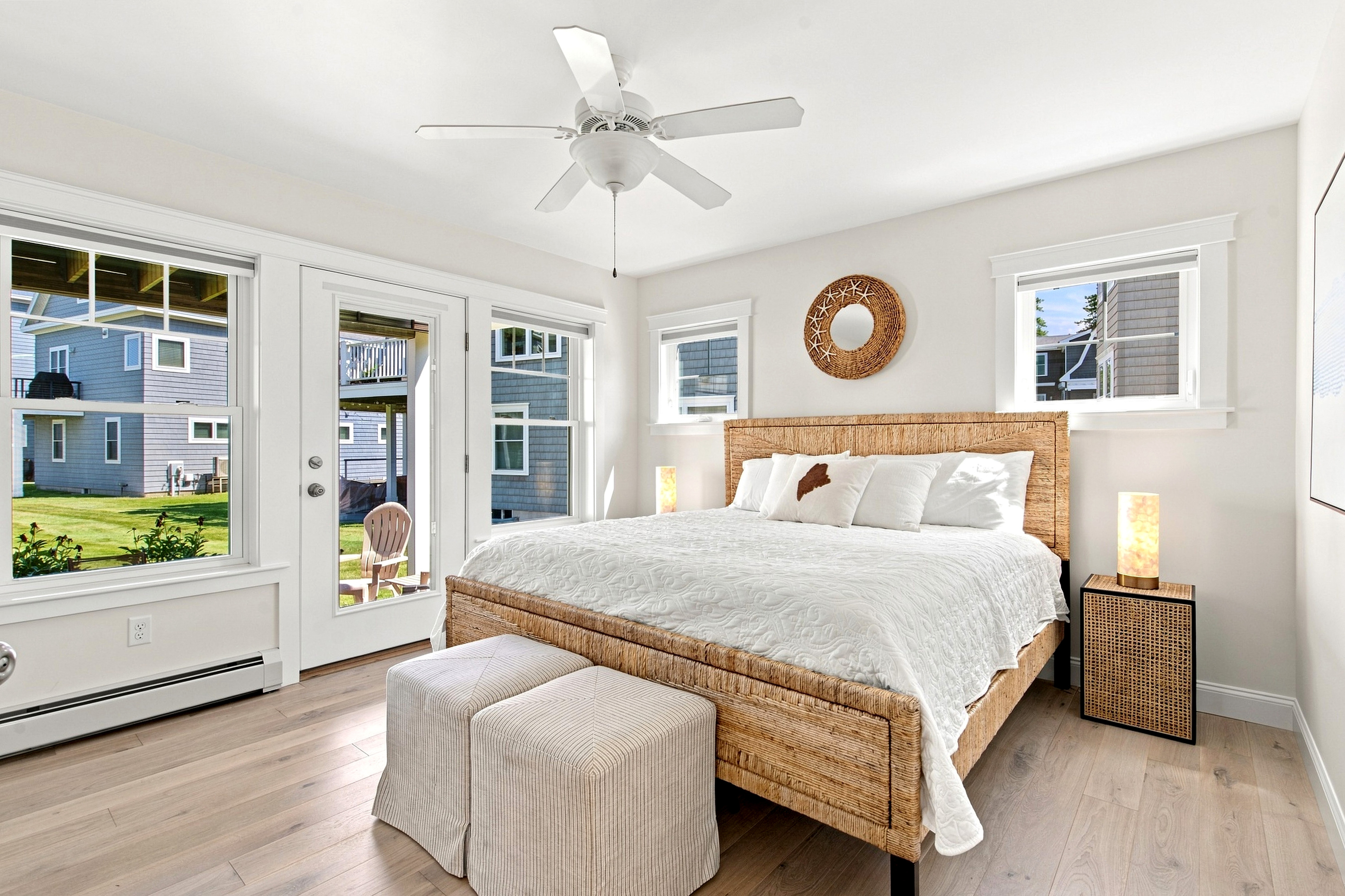 A bright, welcoming bedroom with warm coastal textures and plenty of natural light for a restful stay.