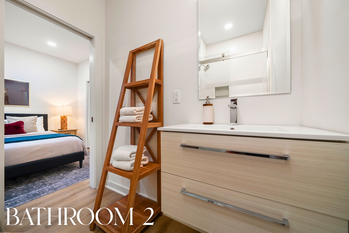 Bathroom 2: Modern and bright with sleek fixtures, fresh towels, and premium toiletries.