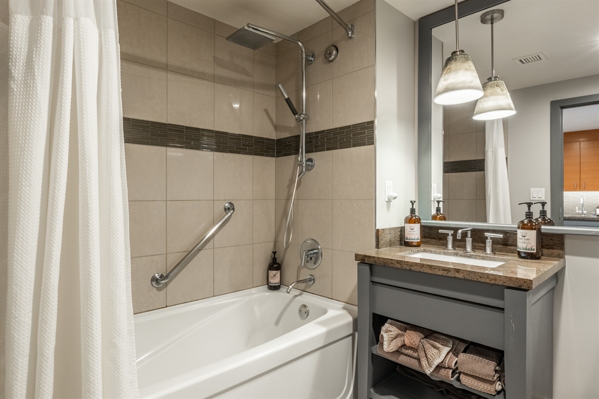 Clean, modern bath with bright finishes and a tub/shower combo.