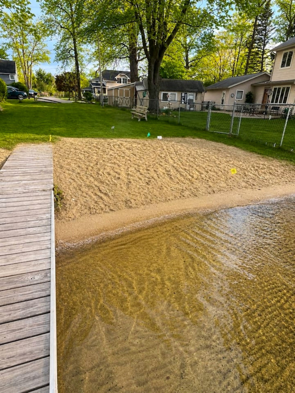 Small beach area next to dock that over looks the Lake. 