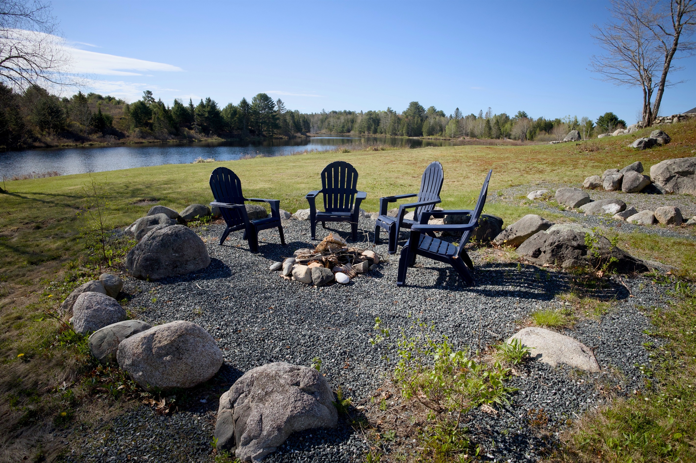 Fire area, steps away from the water. Kindling and firewood available. If we run out, there's plenty of stock along Rt1 for you to buy some