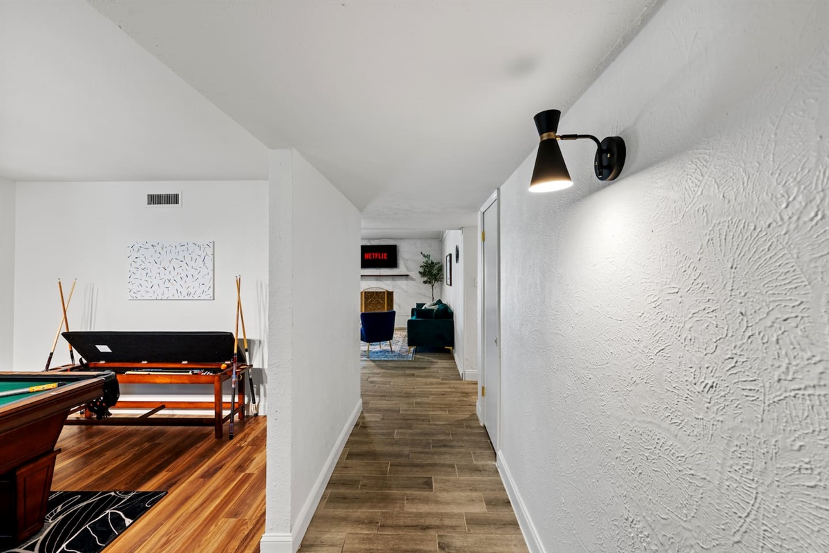 Clean, wide hallway with modern finishes that connect the home’s stylish layout.