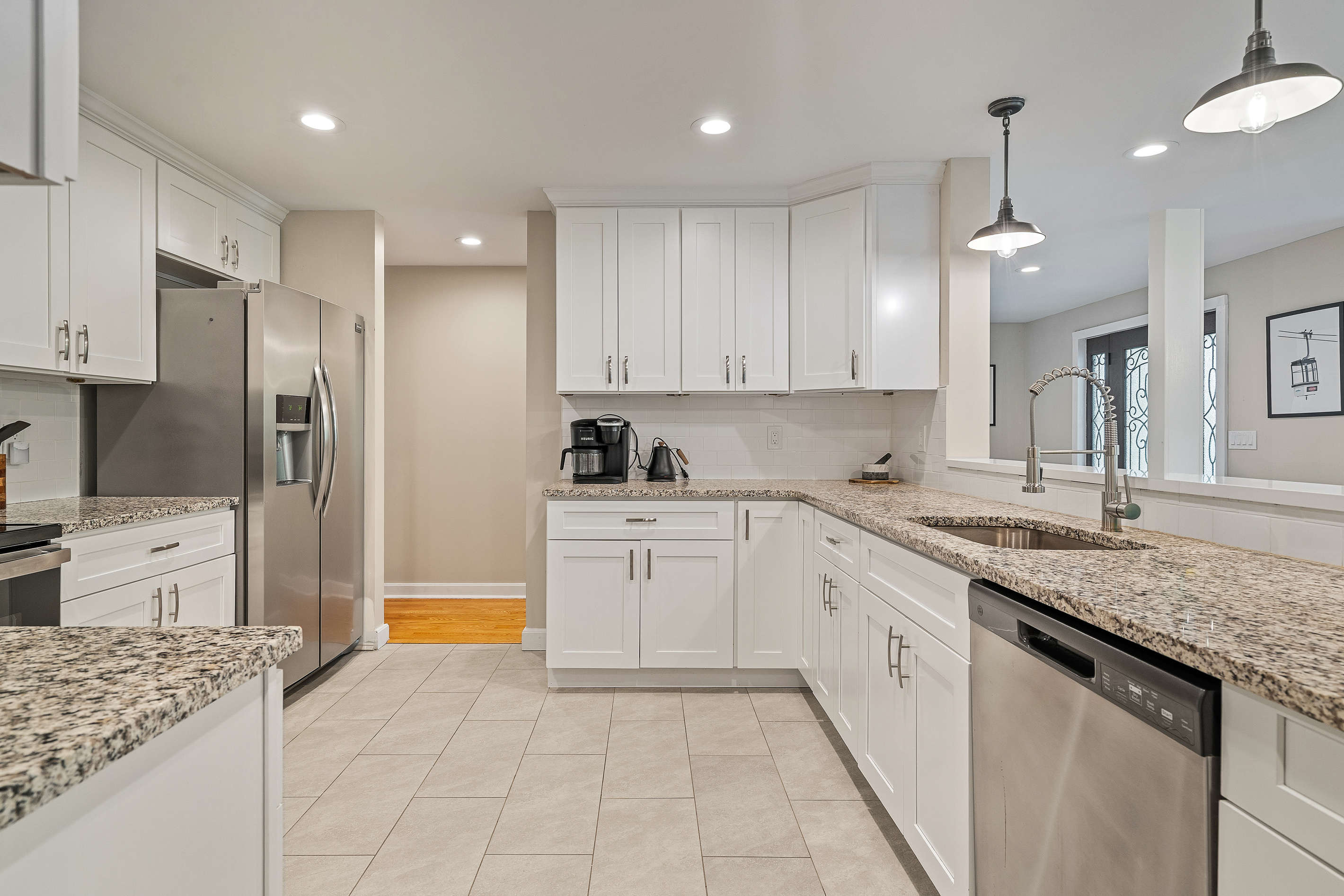 Spacious kitchen with ample counter space and stainless steel refrigerator for large family gatherings
