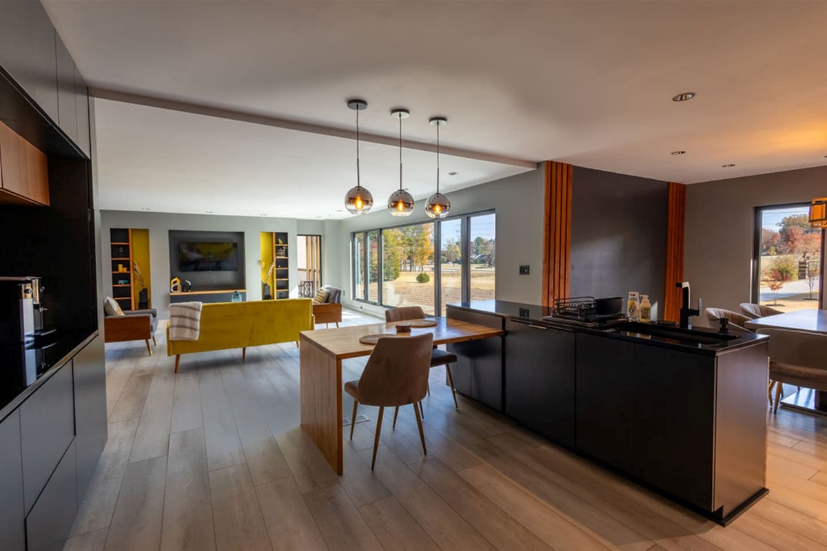 Open view from the kitchen, seamlessly connecting the dining and living areas, creating an inviting, airy space for both cooking and socializing.