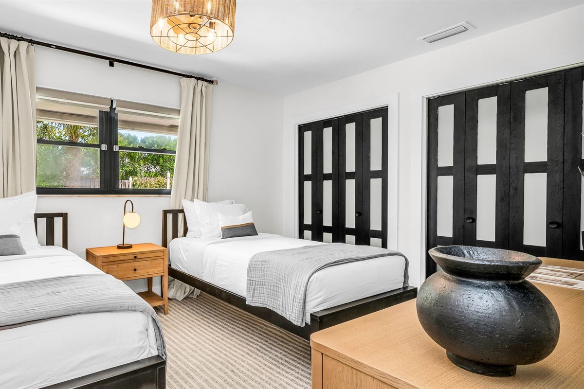 This light-filled twin bedroom combines comfort and style with coastal surf accents, two cozy twin beds, and premium linens. Guests will love the ROKU TV for entertainment and the abundant storage space, all ideally situated across from the guest bath.