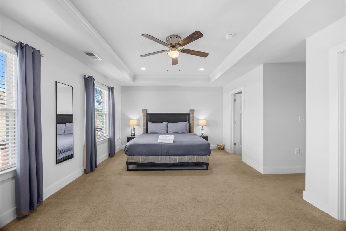 Large windows and elegant tray ceiling create a refreshing atmosphere for restful nights.