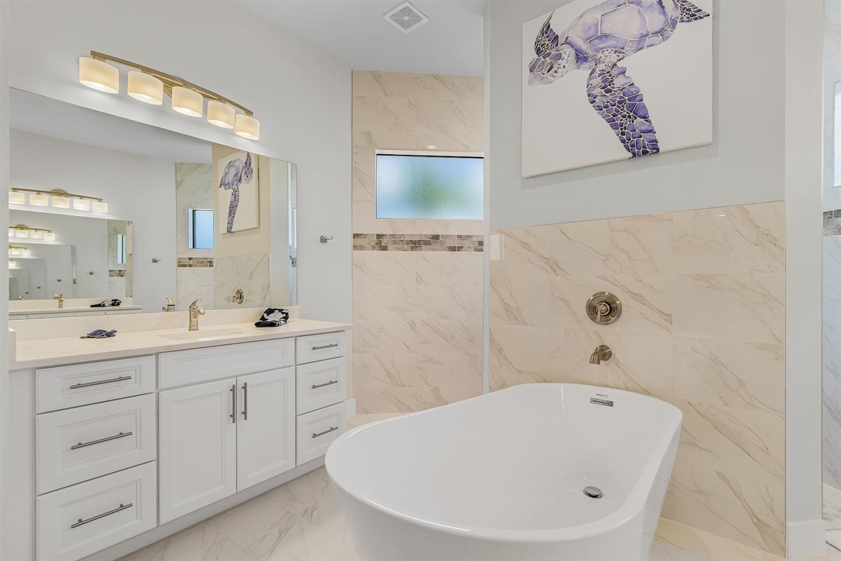 Indulge in the spacious ensuite bathroom complete with two vanities, a relaxing tub, and a separate shower for the ultimate in comfort!