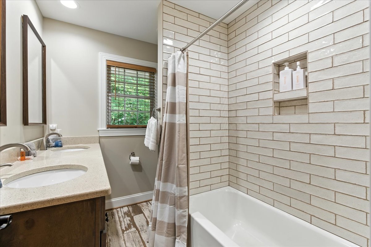 Bathroom equipped with a tub and shower combo.