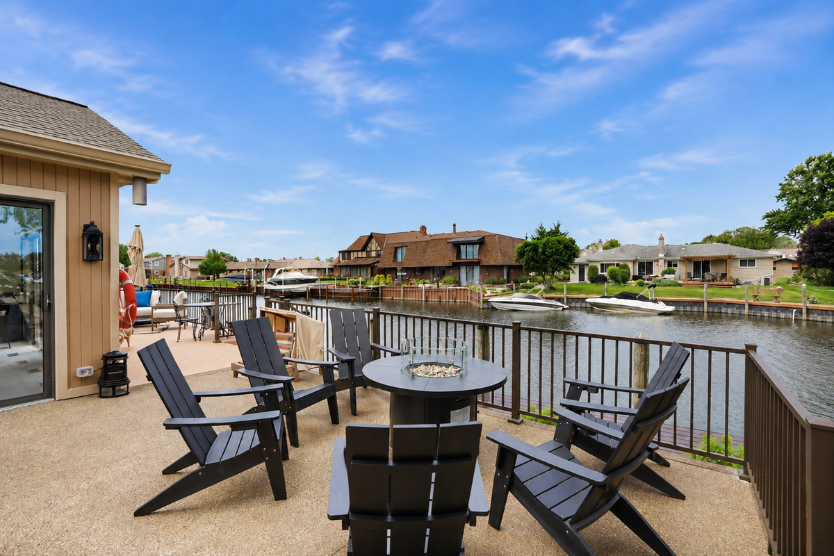 Waterfront seating area with fire pit and canal views—perfect for relaxing, socializing, and enjoying peaceful lakefront living.