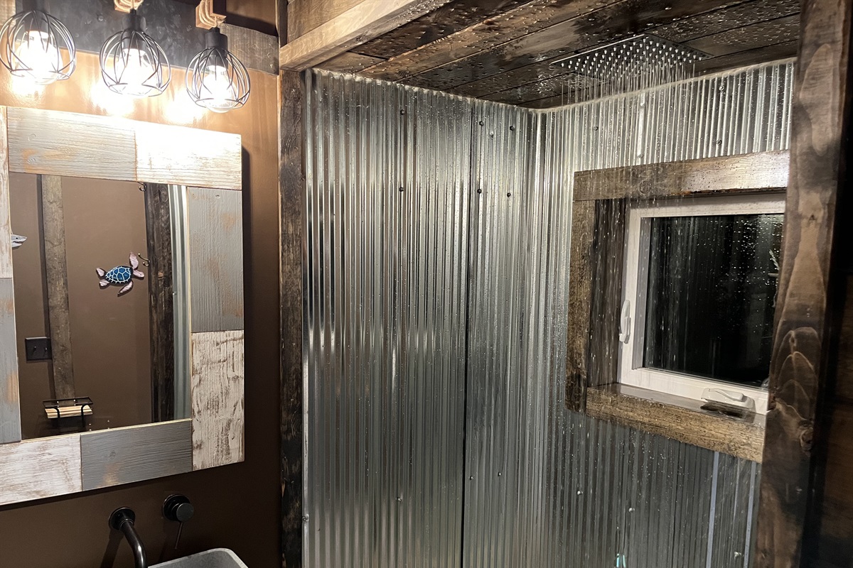 The loft floor bathroom has a rain shower
