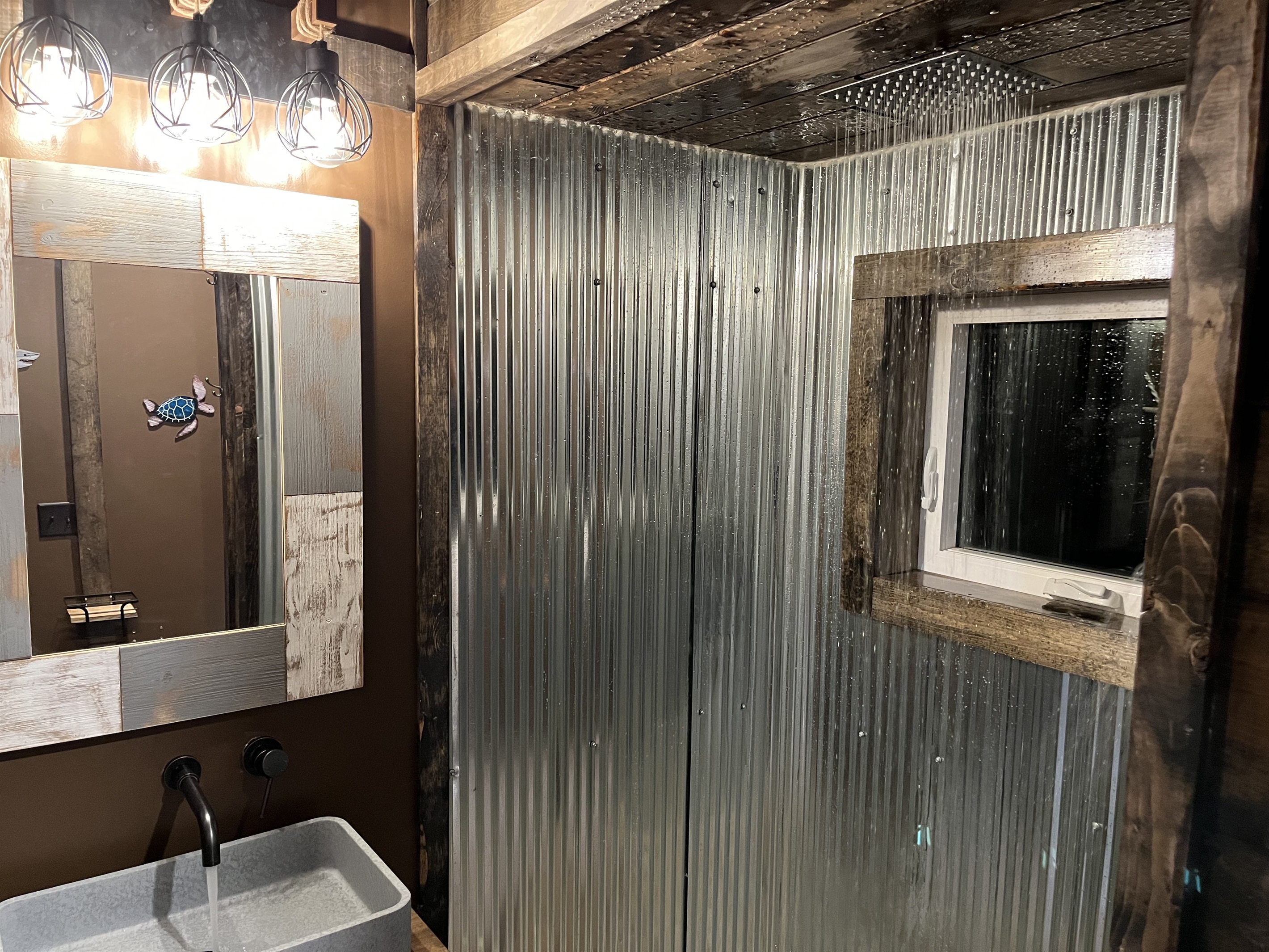 The loft floor bathroom has a rain shower