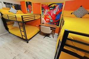 A vibrant and cozy bunk room designed for fun and relaxation. Perfect for unwinding or getting creative in style.