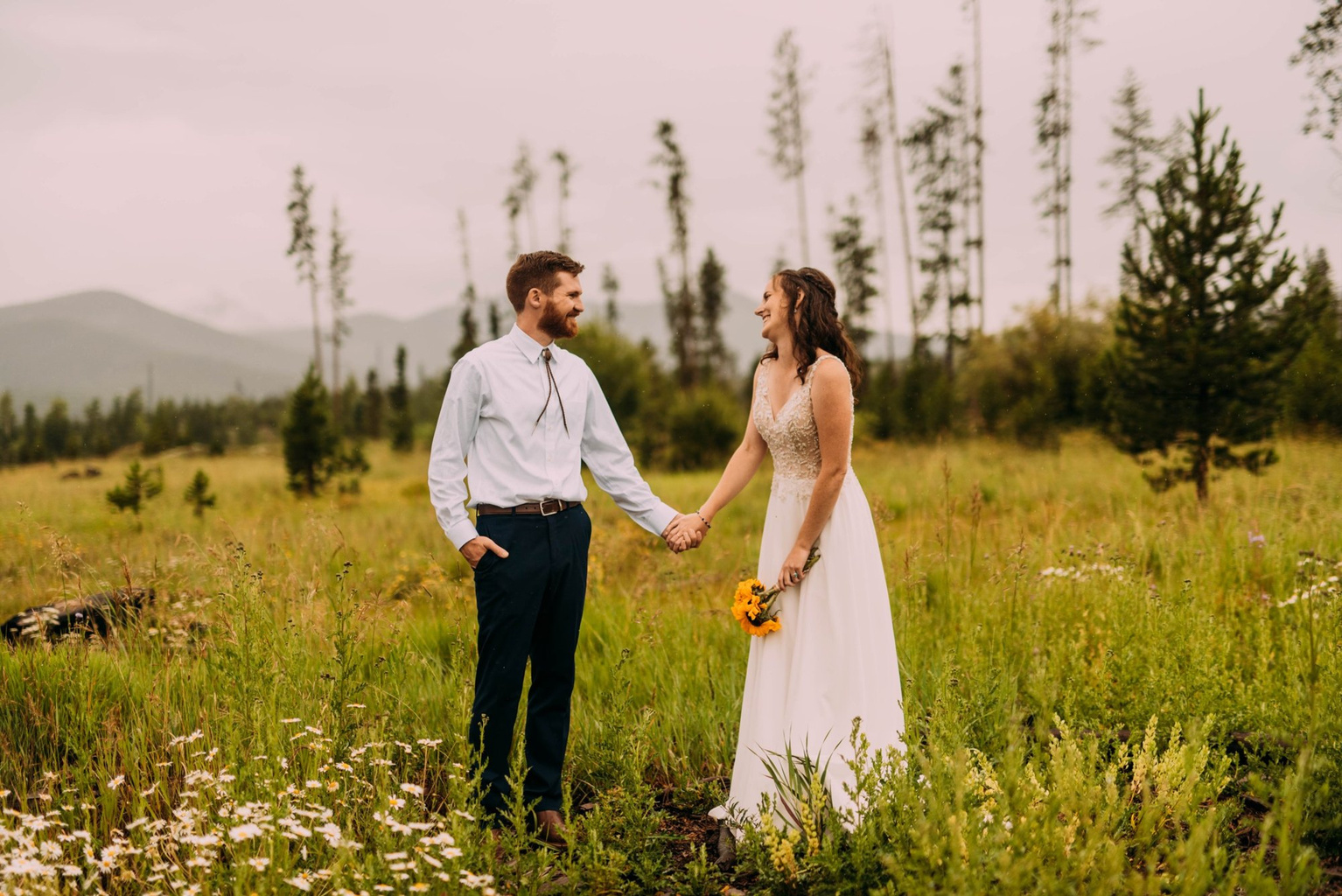 Couple holding hands in the wildflower meadow