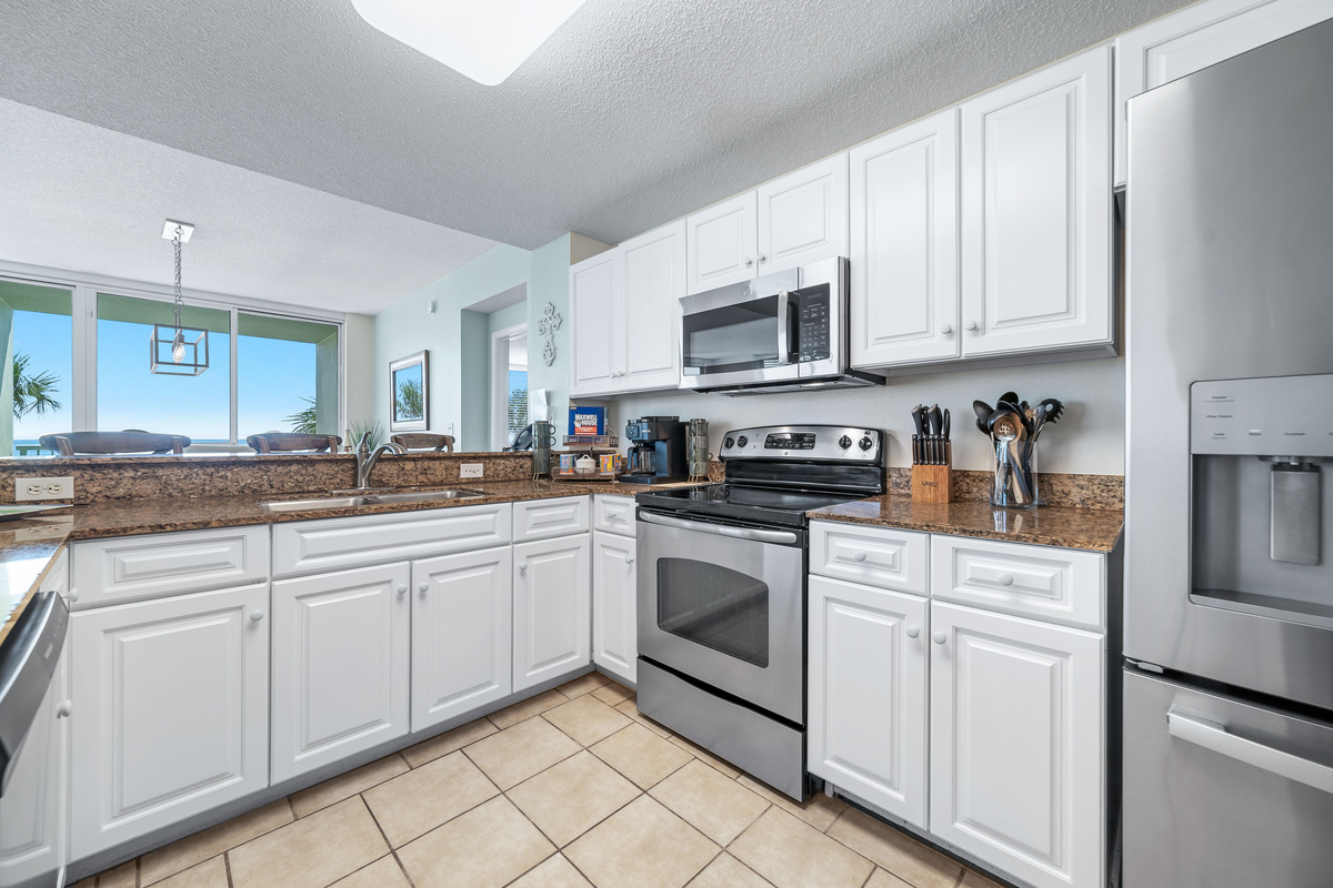 This bright and airy kitchen offers ample counter space, modern cabinetry, and stunning views, perfect for cooking and entertaining.