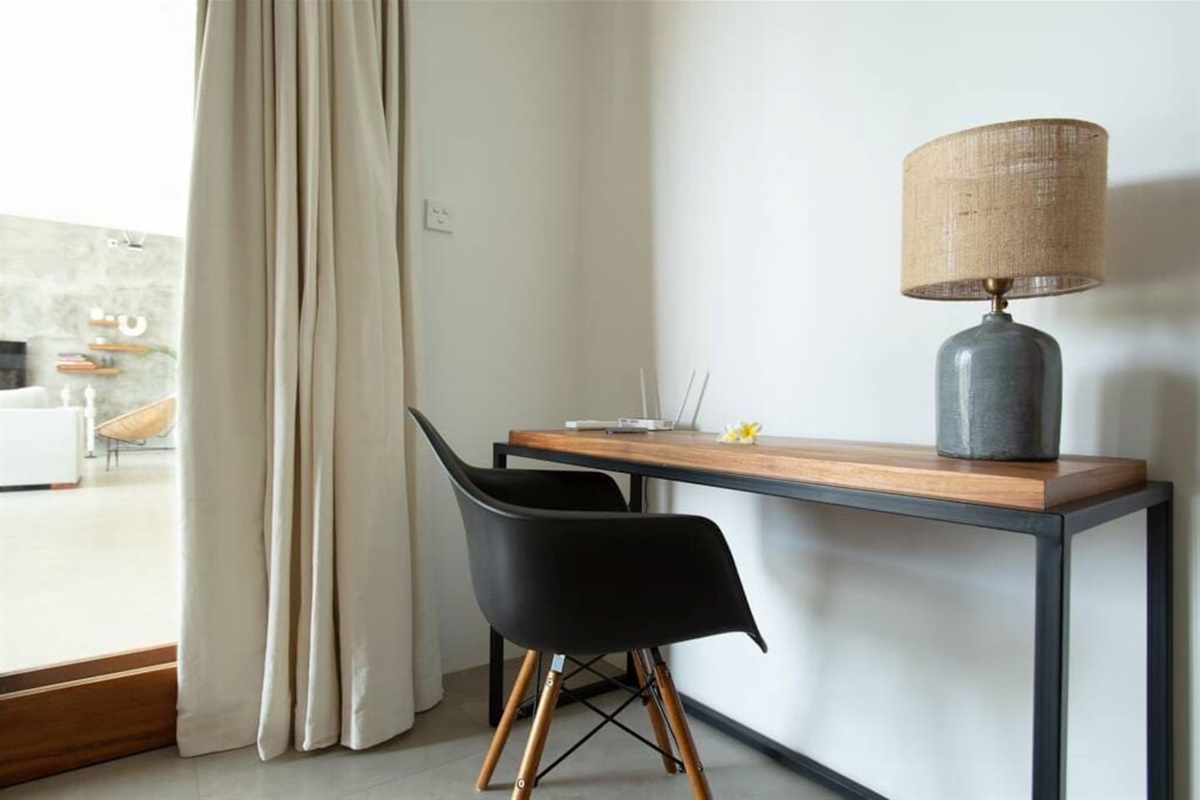 A workspace with a desk, chair, and lamp. Wi-Fi - STRONG AND STABLE INTERNET CONNECTION - 200 Mb/s downstream and upstream - it is even possible to connect via an Ethernet cable