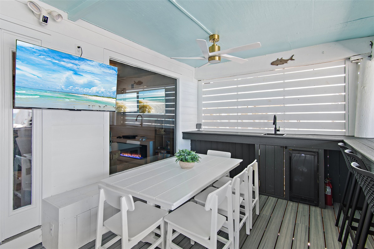 Incredible covered bar & dining area at Green Reef 1 - Plenty of seating to hang and dine, LED lighting, sink, mini-fridge, gas grill + a big Smart TV so you can watch the waves AND the game!
